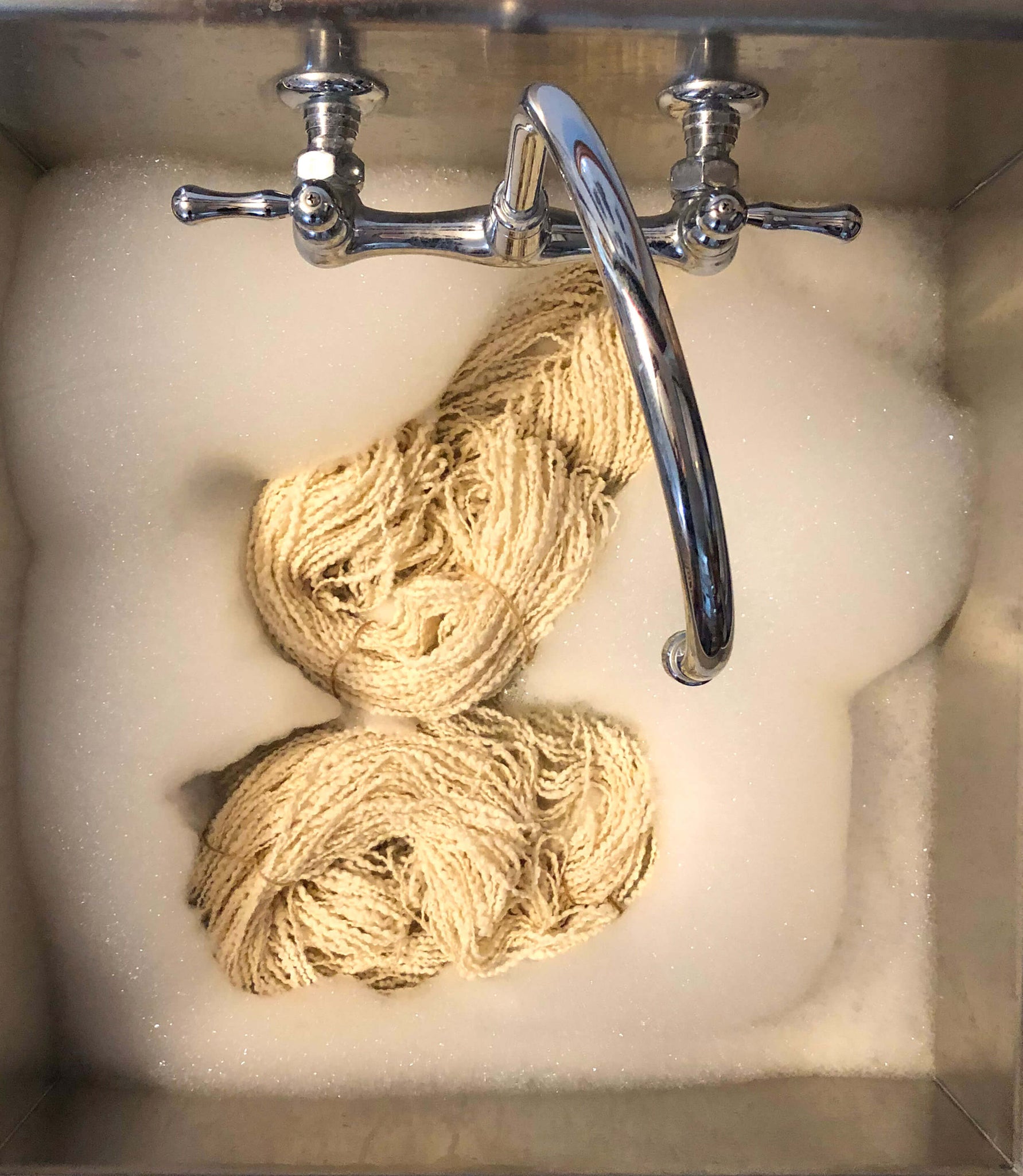 Scouring wool in a sink