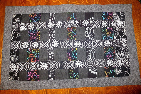handmade insulated quilted table runner in black batiks and calicos 