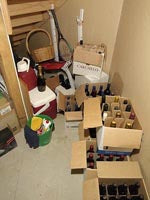 Wine bottles in boxes with the household cleaning supplies