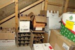 Wine bottles stacked in boxes under the stairs