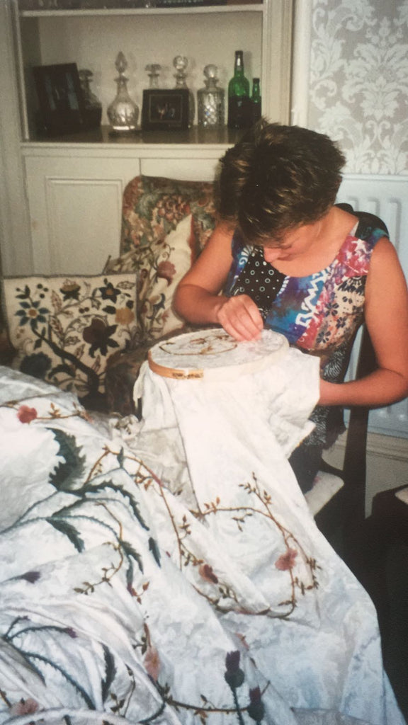 Laura, aged 16, putting some stitches in the Queen Mother's Bedspread