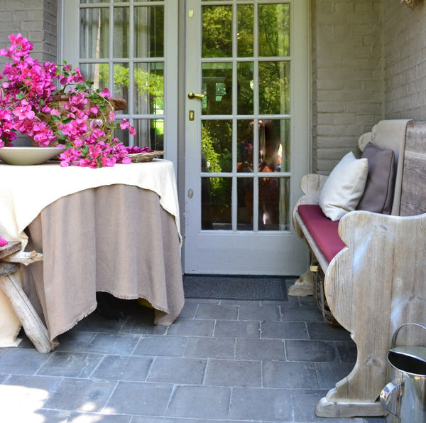 Outdoor dining space with rustic antique bench and bougainvillia - Walda Pairon