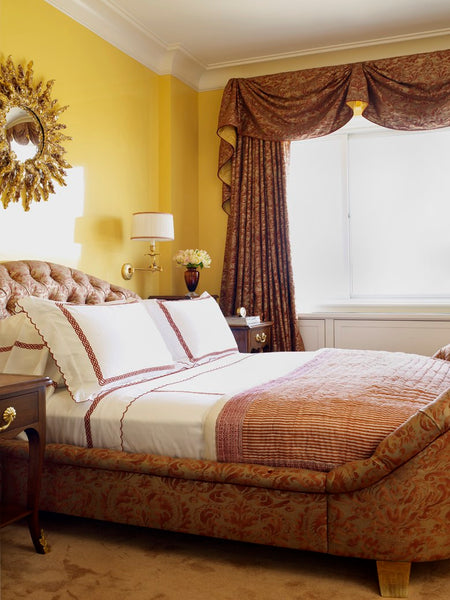 Sunburst mirror over bedroom in classic interior