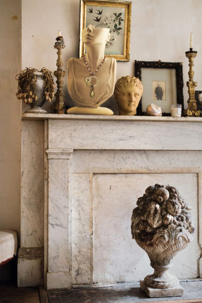 Antique French busts and finial fireplace