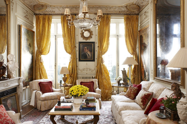 Timothy Corrigan living room with gold sunburst mirror vintage and antique decor