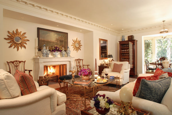 Pair of sunburst mirrors symmetry in living room by Timothy Corrigan