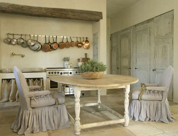 Round table with copper pots and salvaged cupboard doors