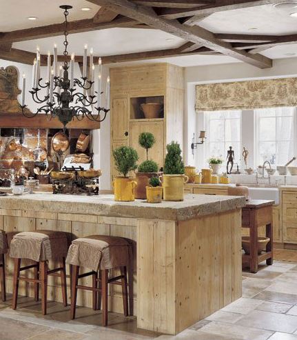Hanging copper pots and Provincial orange pottery in a country kitchen