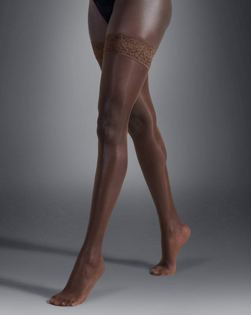 Model wears the Plain Leg Lace Top Hold Ups in Caramel. These dark tan sheer hold up tights perfect under a wedding dress as bridal hold ups. 