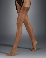 Model wears the Plain Leg Plain Top Hold Up Caramel Stockings. These sheer hold up plain stockings are perfect as bridal stockings, in a dark tan colour.