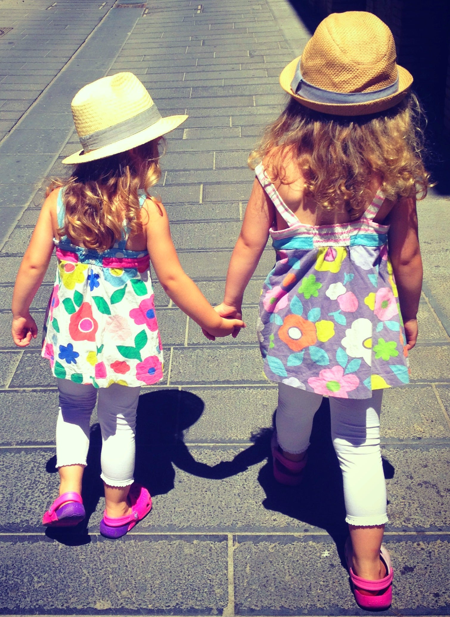 girls walking hand in hand