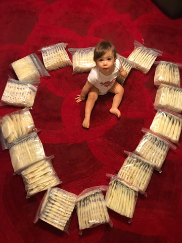Trenton Cabral surrounded by Sabrina's breastmilk donation in the shape of a heart. 