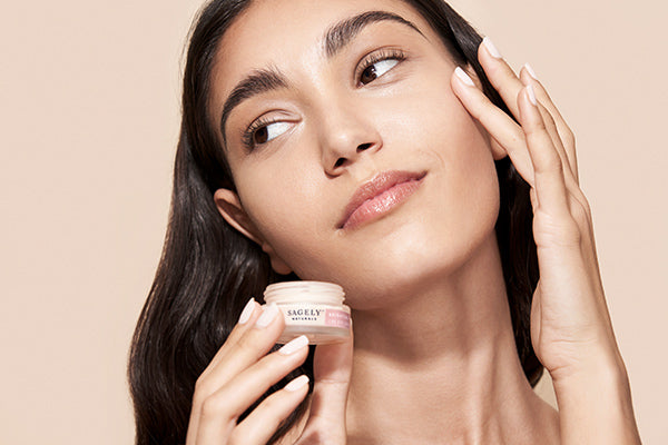 Woman applying Sagely Naturals Brightening CBD Eye Cream 