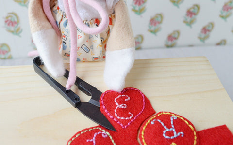 Lucy Owl cutting out her embroidered Valentines