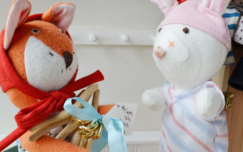Flora Fox delivering finished wooden hangers to rabbit twins