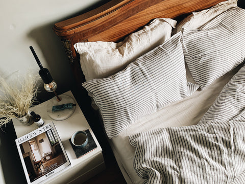 A bed from above with ethical handmade striped bed linen from Aerende