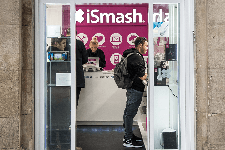 A customer in our Victoria Station store getting his phone repaired