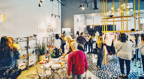 Uni+Koncept uptown waterloo women's lifestyle boutique hosting grand opening event. women shopping at the boutique. 