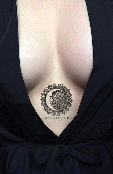 Cool Black Tribal Mandala Sternum Tattoo Ideas for Women - Sacred Geometric Moon Clevage Tat for Teen Girls - www.MyBodiArt.com #tattoos