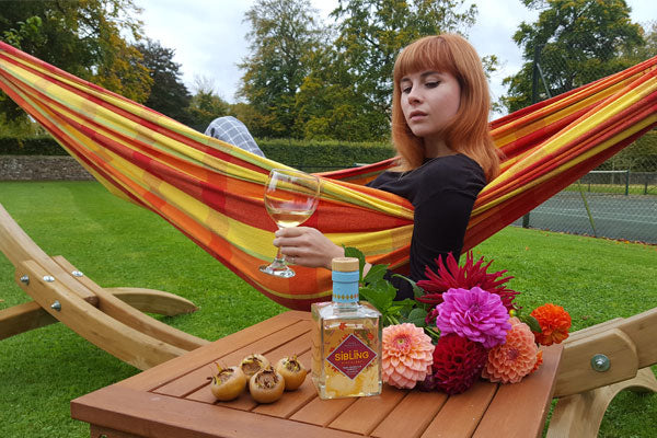 Woman in hammock gin in hand