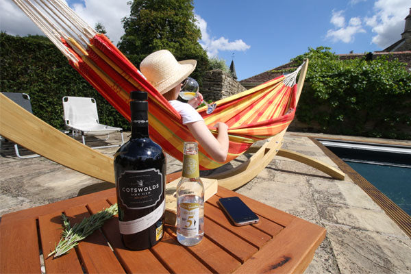 Woman in hammock with Cotswold Dry Gin