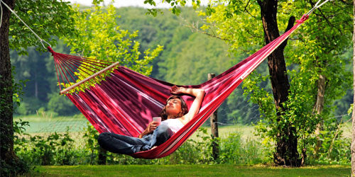 Girl sitting sideways in hammock