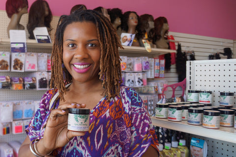 Customer holding Growth + Restore Butter Cream sold at The Girl Cave LA Beauty Supply
