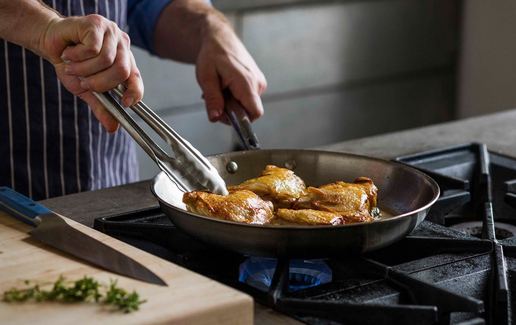 How to cook with stainless steel: A cook sears chicken thighs in a stainless steel skillet