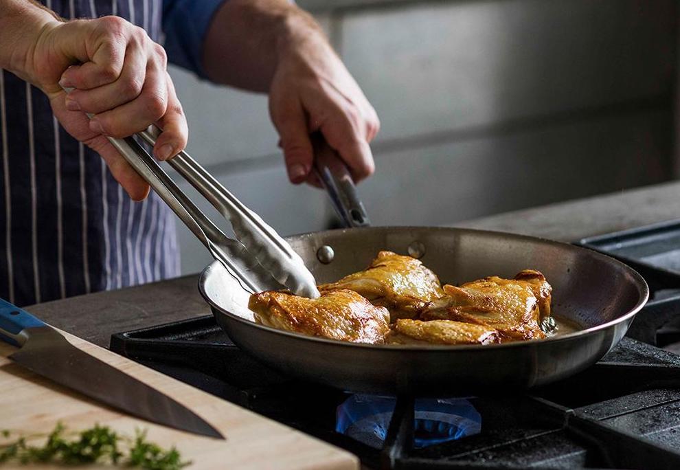 Skillet vs. pan: A home cook makes chicken thighs in a skillet
