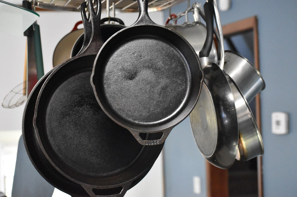 Cast iron oven-safe skillets hanging in a kitchen