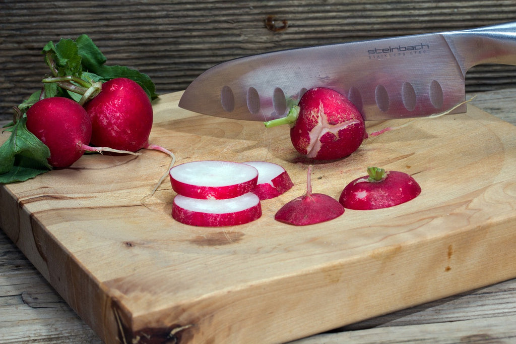 Chefs knives: A knife chops radishes