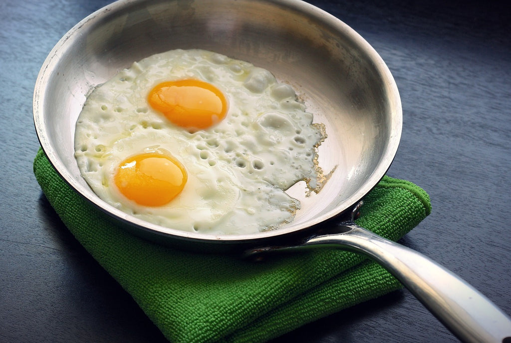 Skillet cooking: fried eggs in a stainless steel skillet