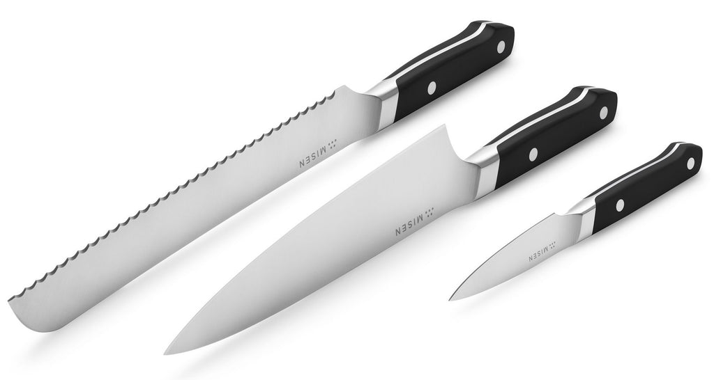 Parts of a knife: a serrated, chef's, and paring knife with the blades facing up
