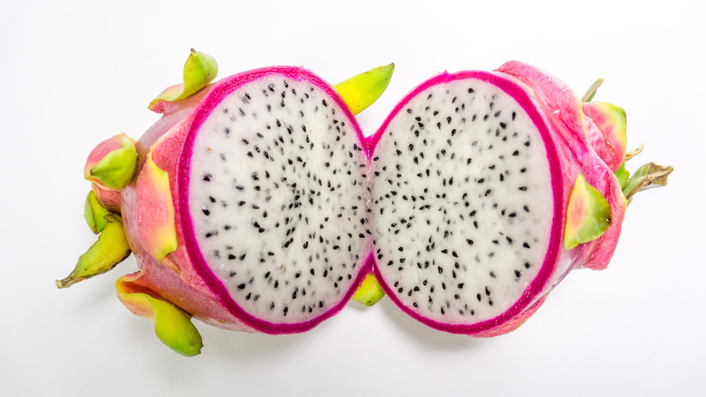 cutting a dragon fruit down the middle 