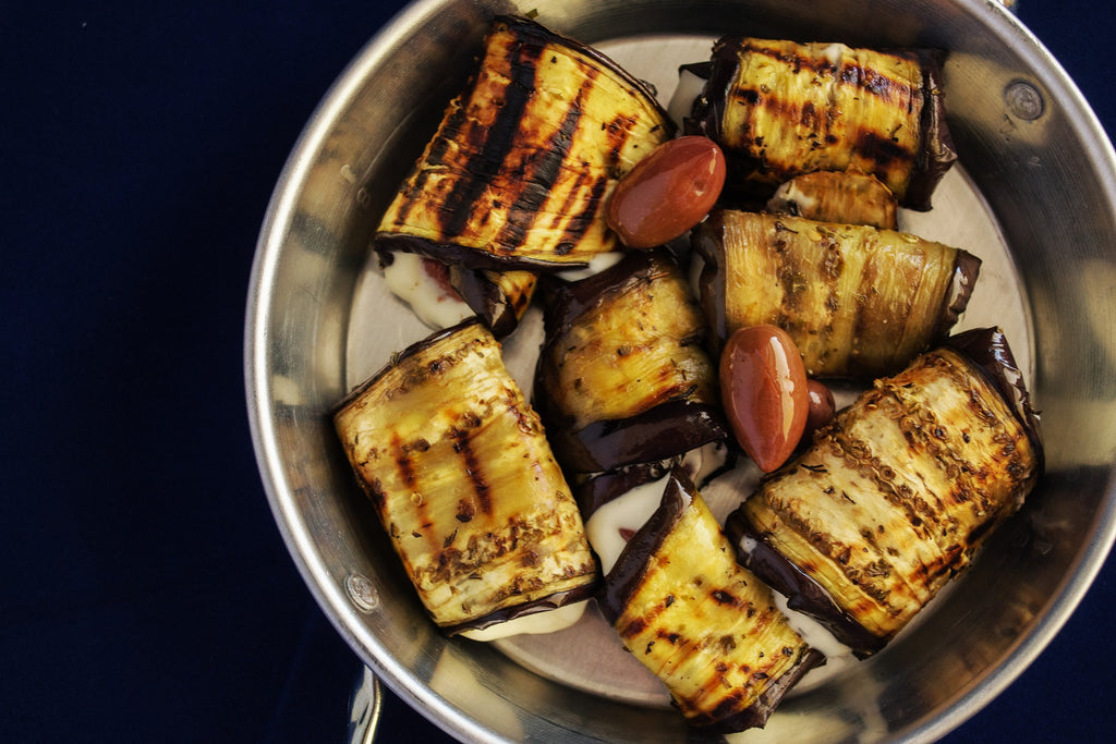 How to cut eggplant: Eggplant planks roasting in a stainless steel pan