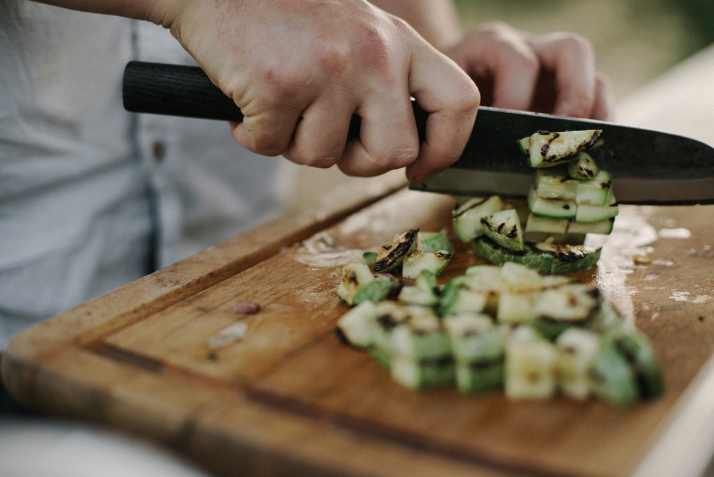 German knives: A chef chops vegetables with a Japanese santoku knife