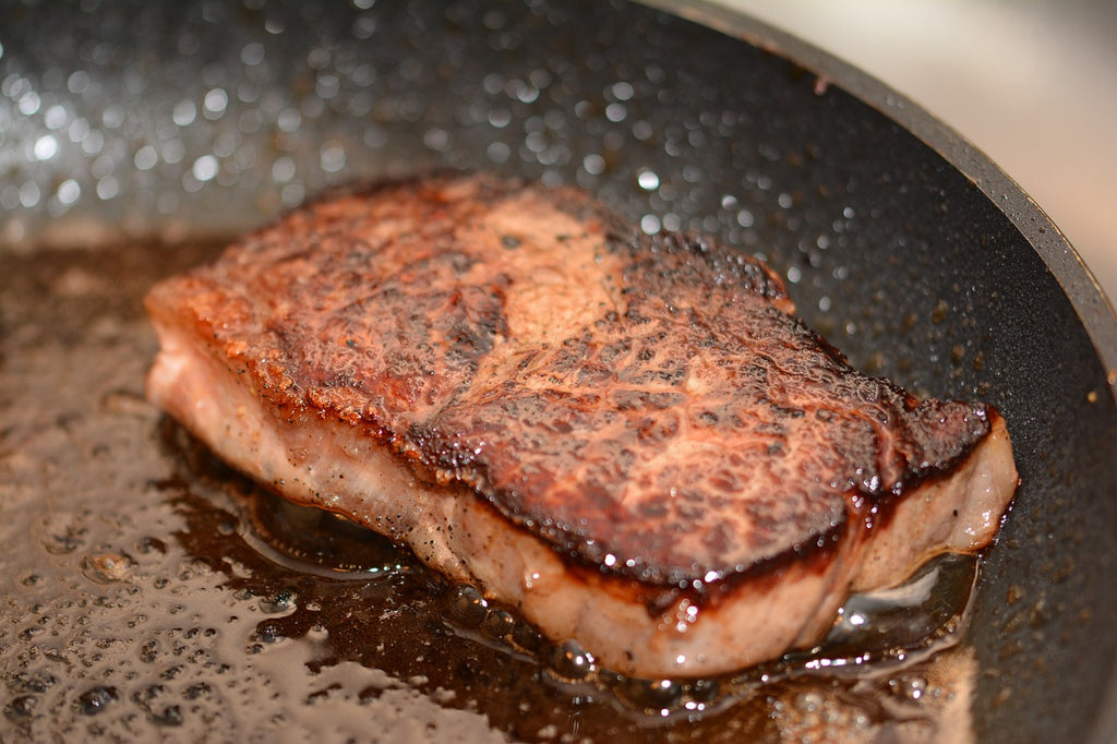 Skillet cooking: a browned pork chop in a pan