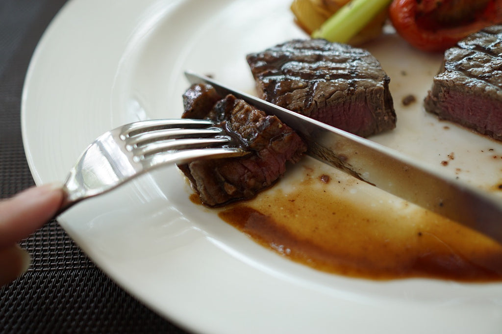 Best steak knives: a fork and knife cut through steak