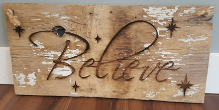 Believe engraved on wood