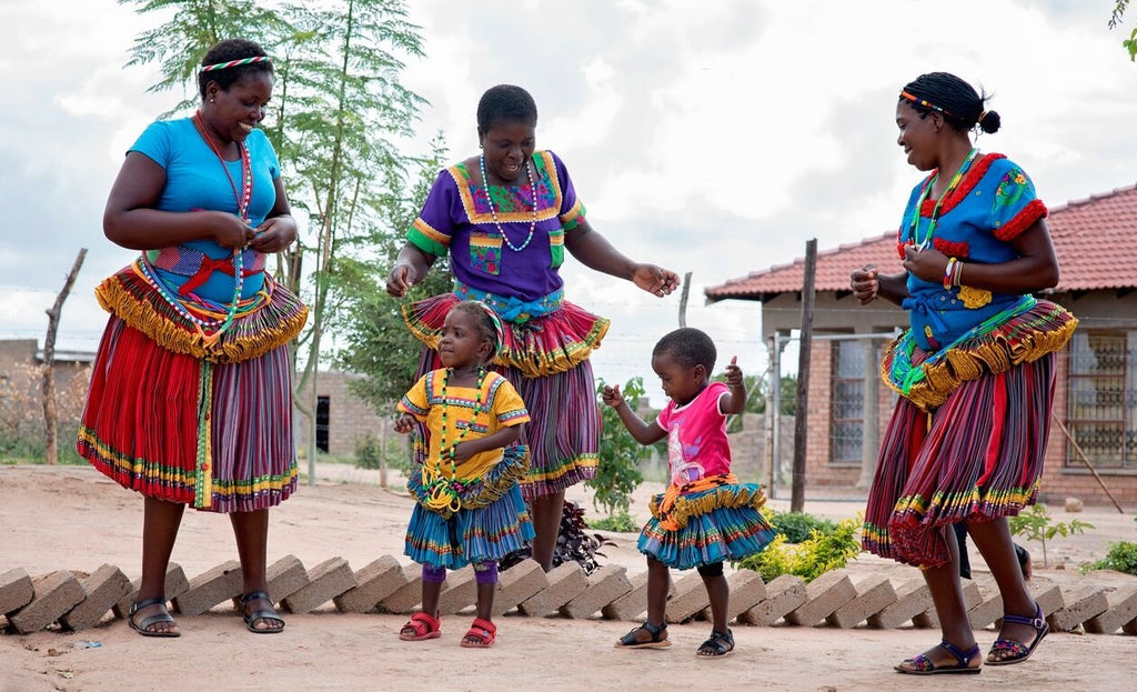 Mashaba family embroiderers and children dancing in vibrant cultural dress