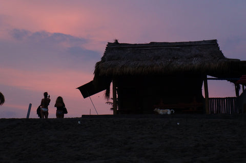 pink old mans beach canggu sunset with surf shacks
