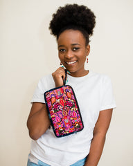 woman holding pink clutch bag and smiling