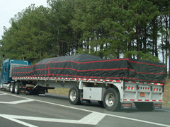 flat bed truck with lumber tarps