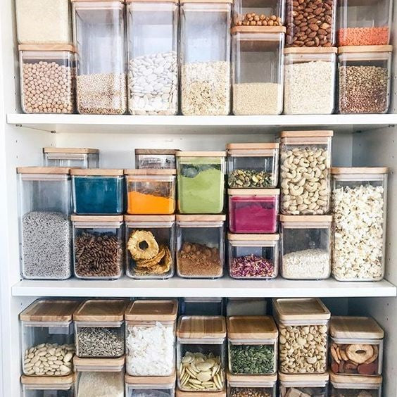 Shelves housing reusable containers filled with a variety of unpackaged foods