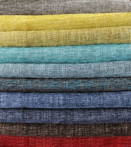 Stack of coloured rolls of fabric