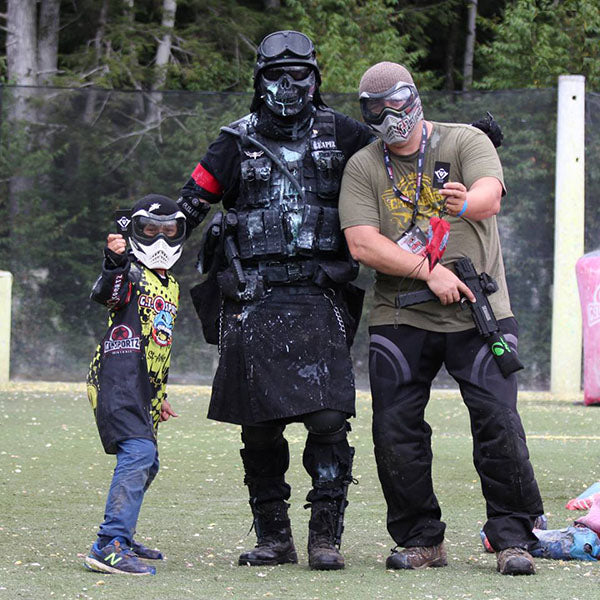 paintball ambassador david justin poses for a photo with two fans