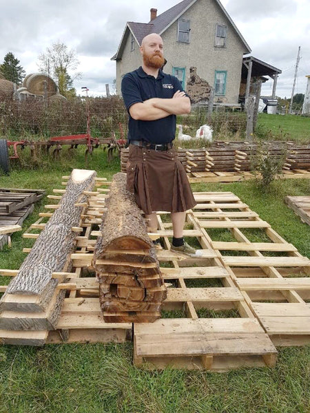 Kilt-wearing craftsman gazes wistfully in to the distance, pondering kilts and Scotland.