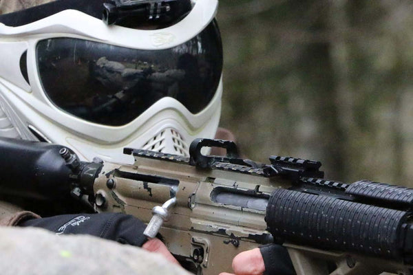 closeup photo of paintball player getting ready to shoot an opponent