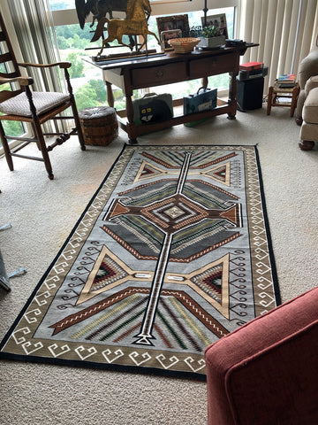 Master Navajo Rug weaver Cecelia Nez's Teec Nos Pos on the floor of an American Indian Rug collector's home