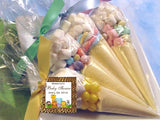 alt="baby shower sweet cone favour. Clear cone shapped cello bag filled with sweets and finished with a ribbon tie and label with baby shower date on"